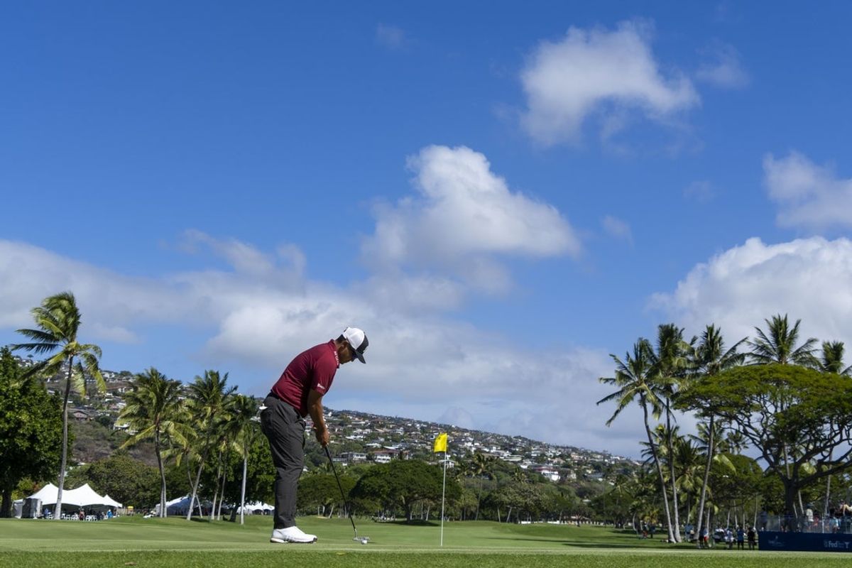 January 10, 2025; Honolulu, Hawaii, USA; Kurt Kitayama putts on the 18th hole during the second round of the Sony Open golf tournament at Waialae Country Club. Mandatory Credit: Kyle Terada-Imagn Images