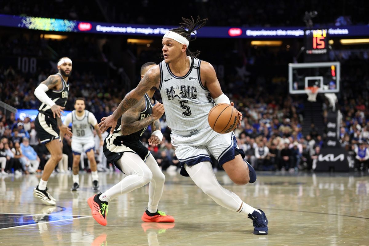Jan 10, 2025; Orlando, Florida, USA; Orlando Magic forward Paolo Banchero (5) drives to the basket against the Milwaukee Bucks in the fourth quarter at Kia Center. Mandatory Credit: Nathan Ray Seebeck-Imagn Images