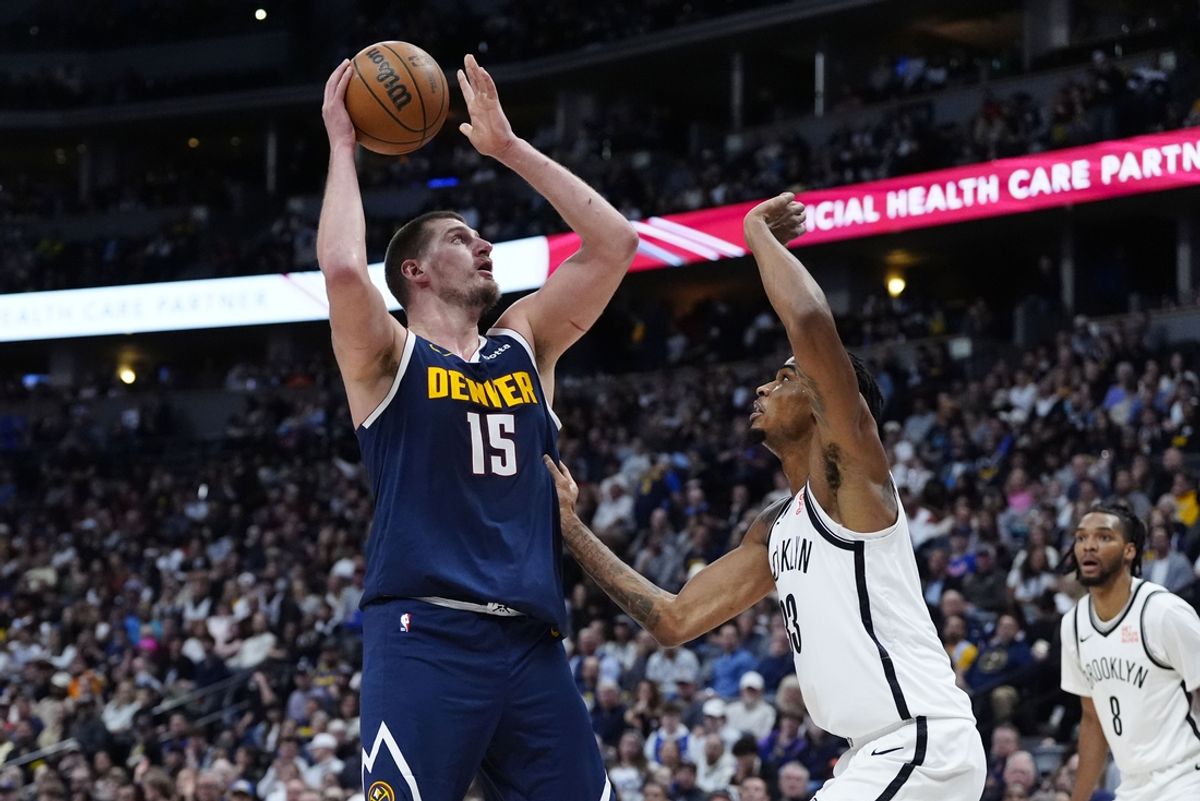 Jan 10, 2025; Denver, Colorado, USA; Brooklyn Nets center Nic Claxton (33) defends on Denver Nuggets center Nikola Jokic (15) in the second quarter at Ball Arena. Mandatory Credit: Ron Chenoy-Imagn Images