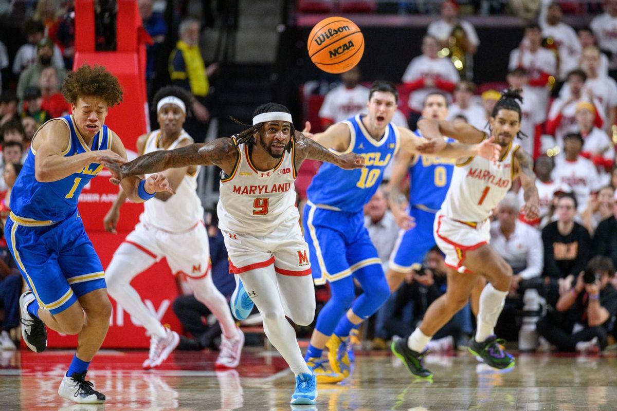 Jan 10, 2025; College Park, Maryland, USA; Maryland Terrapins guard Selton Miguel (9) and UCLA Bruins guard Trent Perry (1) run to a loose ball during the second half at Xfinity Center. Mandatory Credit: Reggie Hildred-Imagn Images
