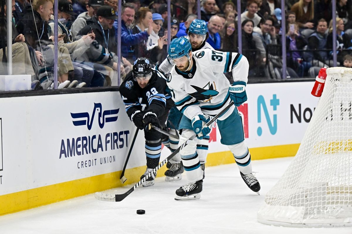 Jan 10, 2025; Salt Lake City, Utah, USA; San Jose Sharks defenseman Timothy Liljegren (37) and Utah Hockey Club center Jack McBain (22) battle for the puck during second period at the Delta Center. Mandatory Credit: Christopher Creveling-Imagn Images
