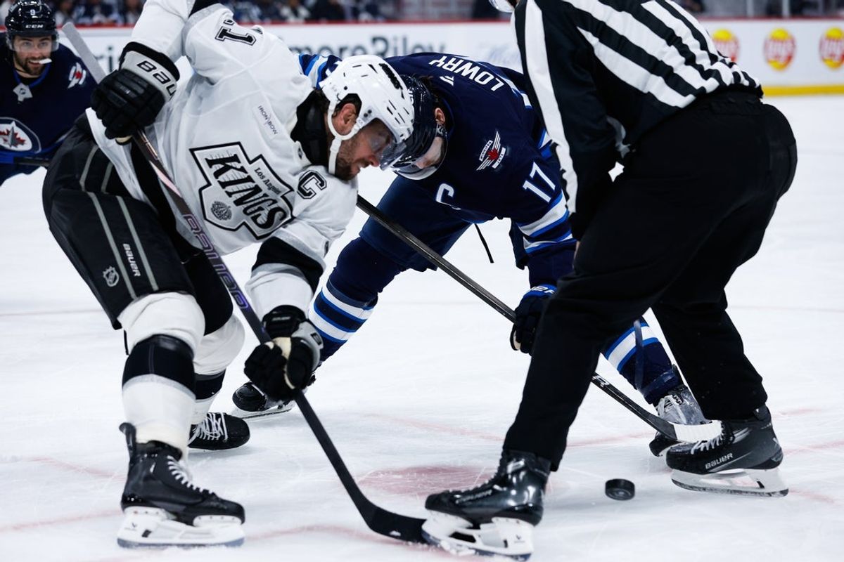 Jan 10, 2025; Winnipeg, Manitoba, CAN; Los Angeles Kings forward Anze Kopitar (11) faces off against Winnipeg Jets forward Gabriel Vilardi (13) during the second period at Canada Life Centre. Mandatory Credit: Terrence Lee-Imagn Images