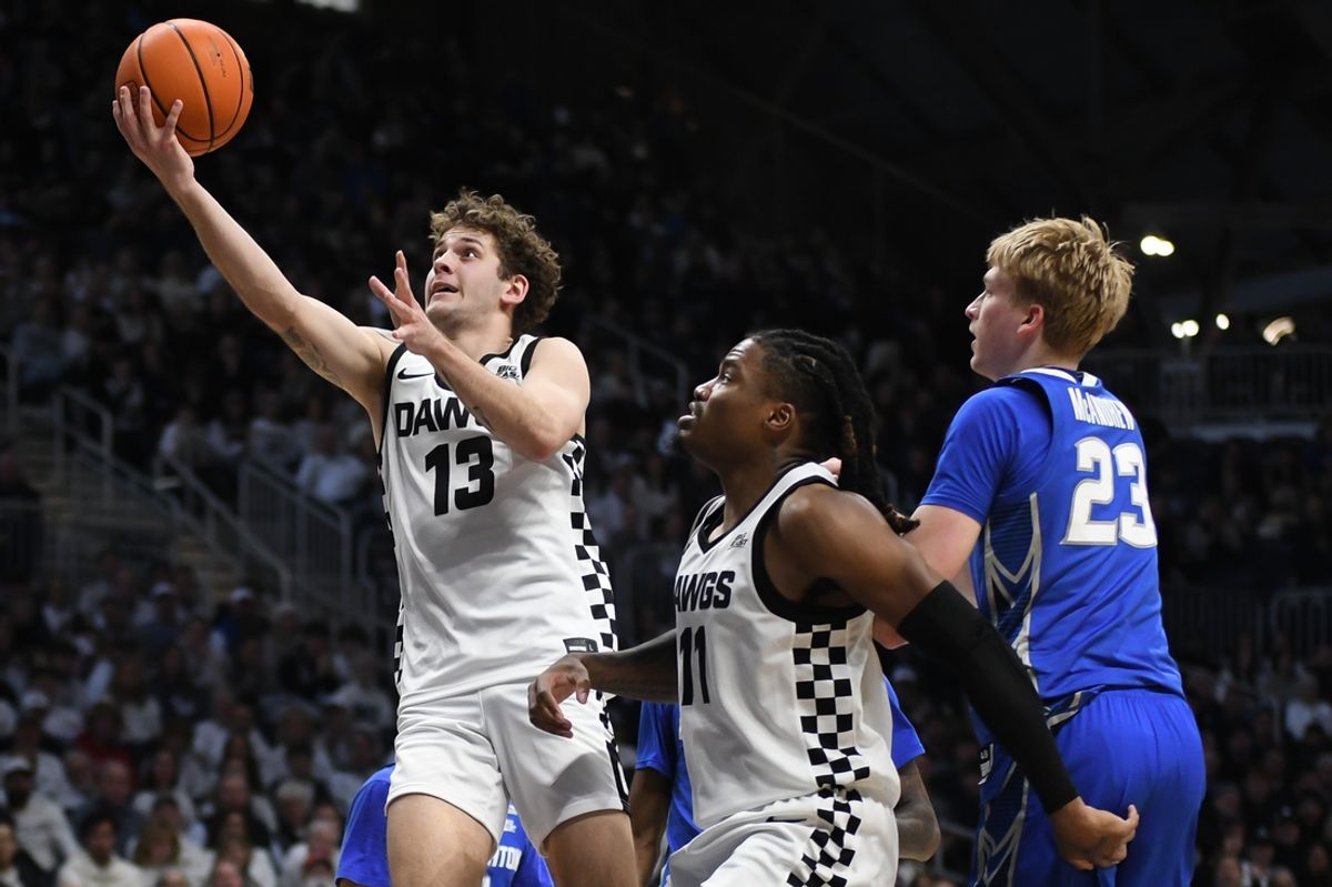 Jan 11, 2025; Indianapolis, Indiana, USA;  Butler Bulldogs guard Finley Bizjack (13) goes to the basket past Creighton Bluejays forward Jackson McAndrew (23) during the first half at Hinkle Fieldhouse. Mandatory Credit: Robert Goddin-Imagn Images