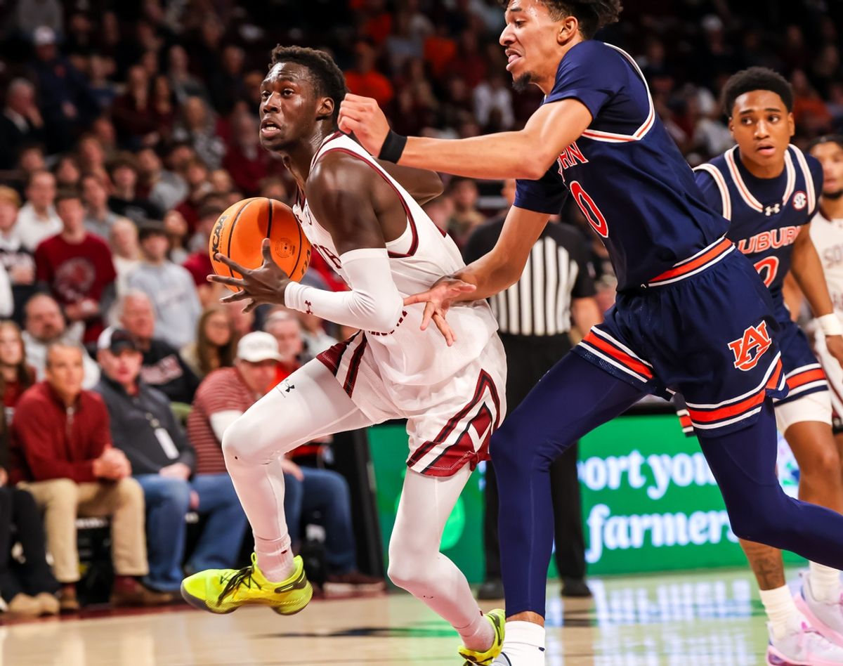 Jan 11, 2025; Columbia, South Carolina, USA; South Carolina Gamecocks guard Morris Ugusuk (15) drives past Auburn Tigers guard Chad Baker-Mazara (10) in the first half at Colonial Life Arena. Mandatory Credit: Jeff Blake-Imagn Images