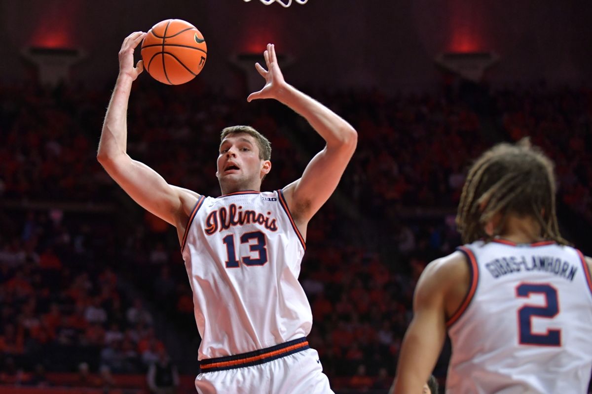 Jan 11, 2025; Champaign, Illinois, USA;  Illinois Fighting Illini center Tomislav Ivisic (13) grabs a rebound during the second half against the USC Trojans at State Farm Center. Mandatory Credit: Ron Johnson-Imagn Images