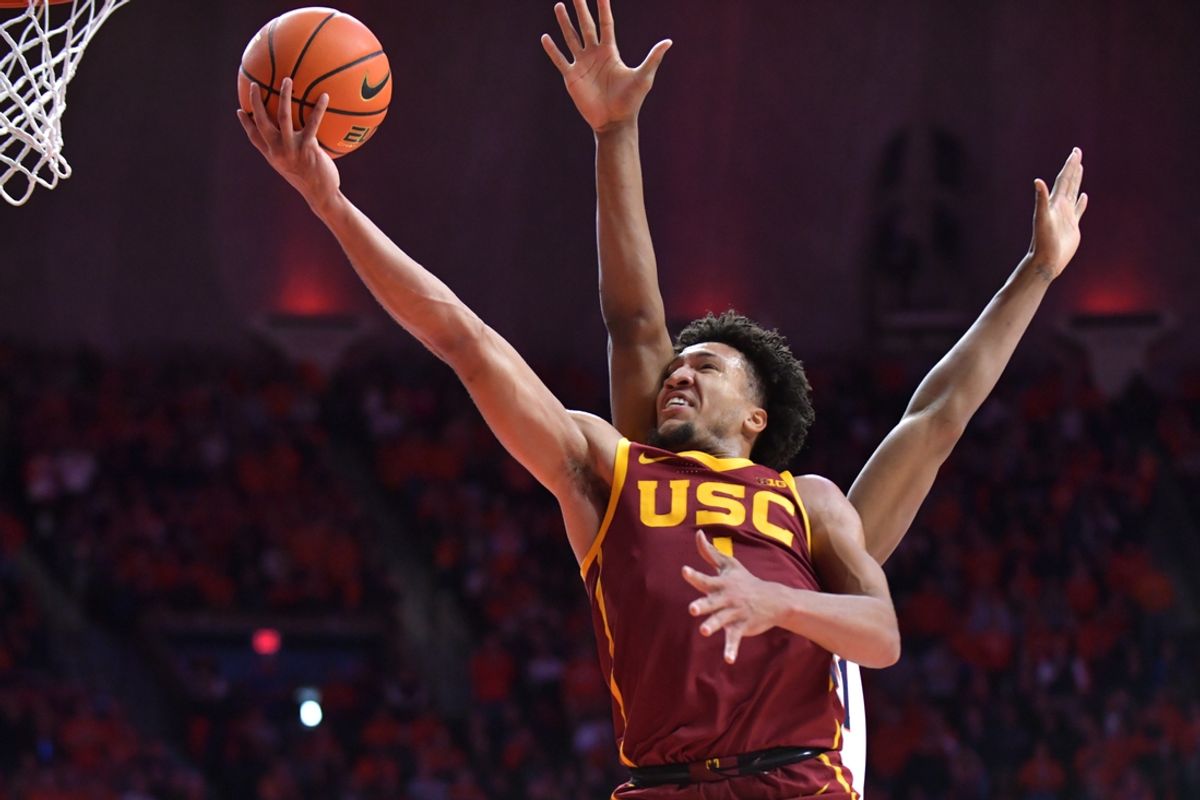 Jan 11, 2025; Champaign, Illinois, USA;  USC Trojans guard Desmond Claude (1) drives past Illinois Fighting Illini forward Morez Johnson Jr. (21) and to the basket during the second half at State Farm Center. Mandatory Credit: Ron Johnson-Imagn Images
