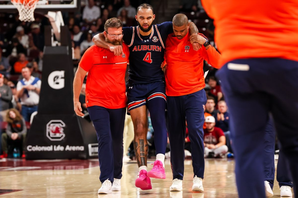 Jan 11, 2025; Columbia, South Carolina, USA; Auburn Tigers forward Johni Broome (4) is helped off the court after sustaining an apparent injury in the second half against the South Carolina Gamecocks at Colonial Life Arena. Mandatory Credit: Jeff Blake-Imagn Images