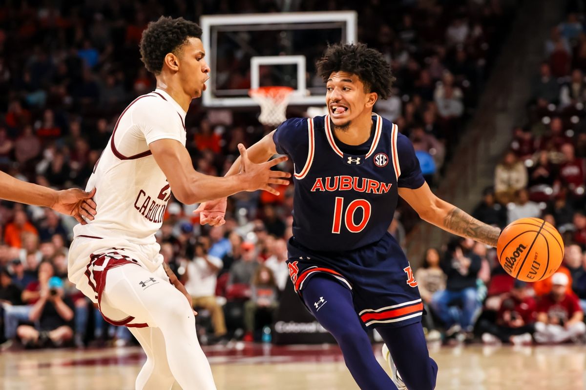 Jan 11, 2025; Columbia, South Carolina, USA; Auburn Tigers guard Chad Baker-Mazara (10) drives around South Carolina Gamecocks guard Arden Conyers (21) in the second half at Colonial Life Arena. Mandatory Credit: Jeff Blake-Imagn Images