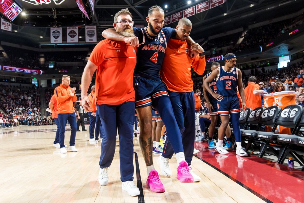 Jan 11, 2025; Columbia, South Carolina, USA; Auburn Tigers forward Johni Broome (4) is helped off the court after being injured against the South Carolina Gamecocks in the second half at Colonial Life Arena. Mandatory Credit: Jeff Blake-Imagn Images