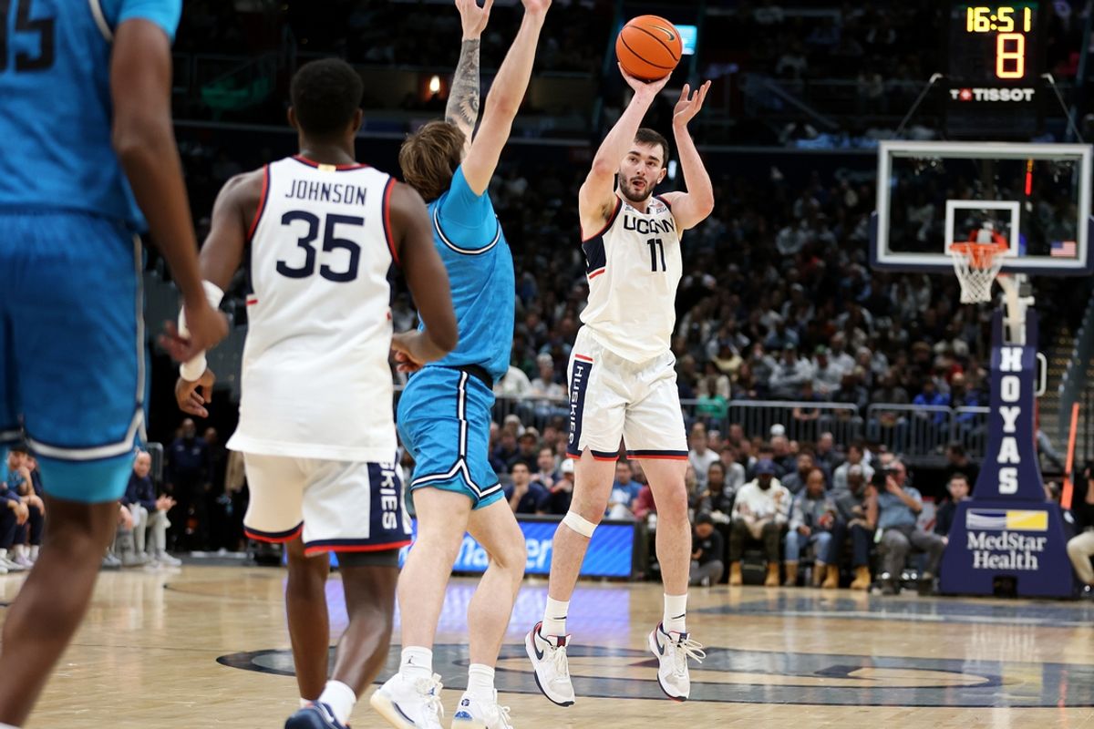 Jan 11, 2025; Washington, District of Columbia, USA; Connecticut Huskies forward Alex Karaban (11) takes a shot over Georgetown Hoyas forward Drew Fielder (20) during the second half at Capital One Arena. Mandatory Credit: Daniel Kucin Jr.-Imagn Images