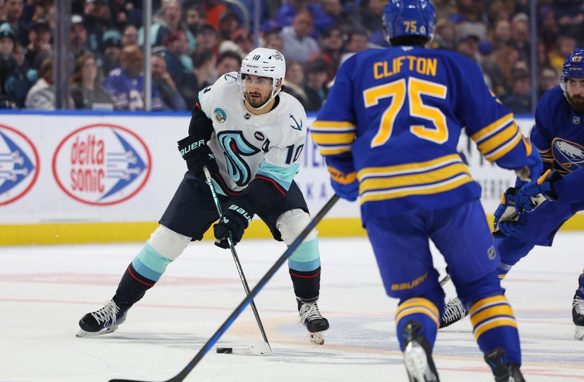 Jan 11, 2025; Buffalo, New York, USA;  Seattle Kraken center Matty Beniers (10) looks to make a pass during the first period against the Buffalo Sabres at KeyBank Center. Mandatory Credit: Timothy T. Ludwig-Imagn Images