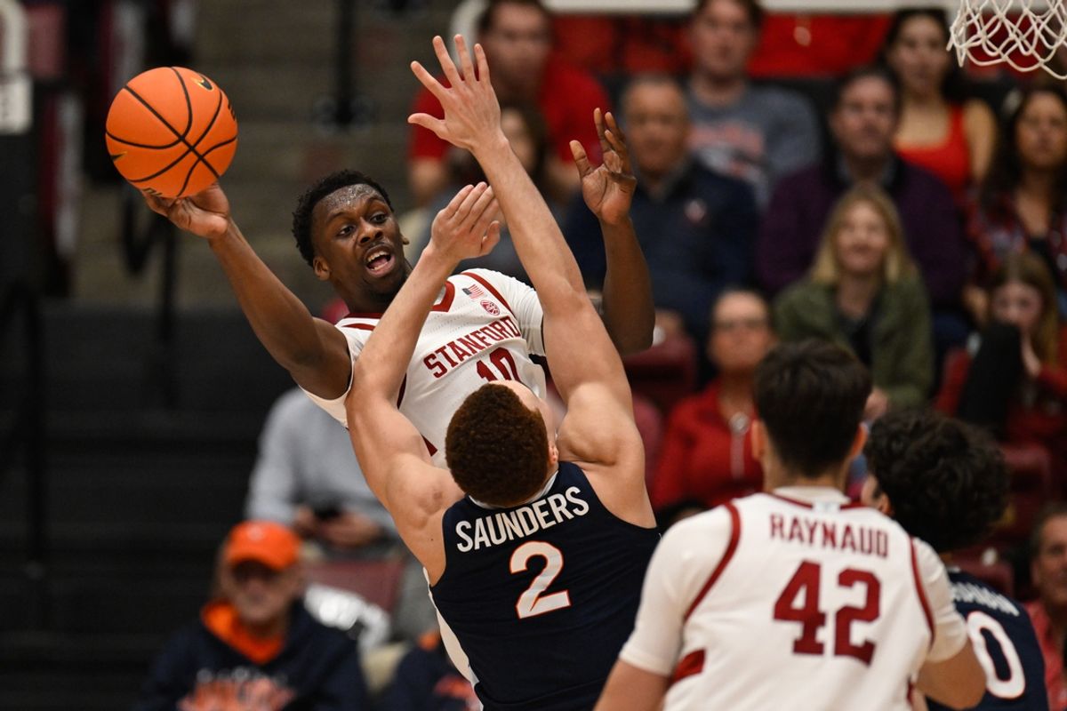 Jan 11, 2025; Stanford, California, USA; Stanford Cardinal forward Chisom Okpara (10) passes the ball while under pressure from Virginia Cavaliers forward Elijah Saunders (2) in the first half at Maples Pavilion. Mandatory Credit: Eakin Howard-Imagn Images