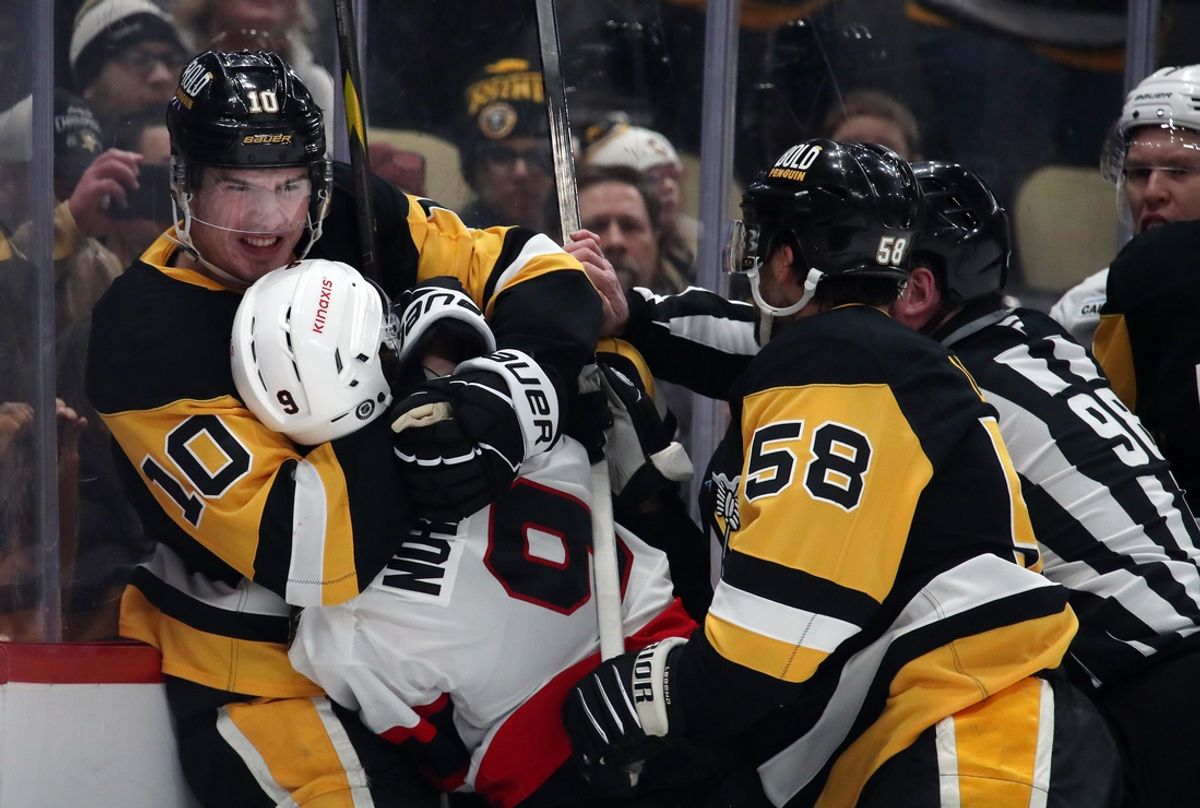 Jan 11, 2025; Pittsburgh, Pennsylvania, USA;  Pittsburgh Penguins left wing Drew O'Connor (10) puts Ottawa Senators center Josh Norris (9) in a headlock as Pens defenseman Kris Letang and linesman Dan Kelly (98) intervene during the first period  at PPG Paints Arena. Mandatory Credit: Charles LeClaire-Imagn Images