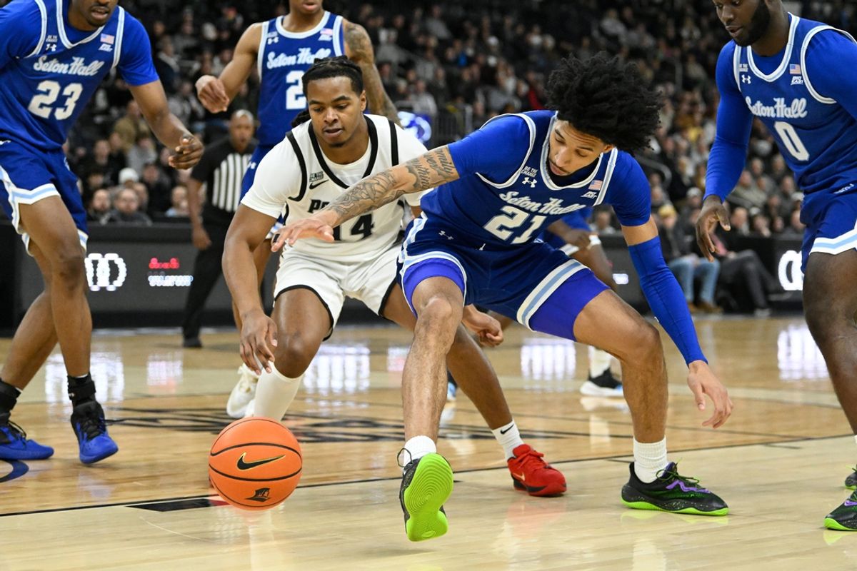 Jan 11, 2025; Providence, Rhode Island, USA; Seton Hall Pirates guard Isaiah Coleman (21) battles Providence Friars guard Corey Floyd Jr. (14) for the loose ball during the first half at Amica Mutual Pavilion. Mandatory Credit: Eric Canha-Imagn Images