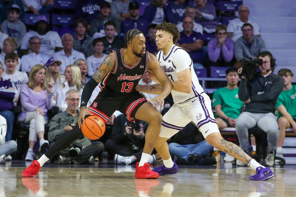 Jan 11, 2025; Manhattan, Kansas, USA; Houston Cougars forward J’wan Roberts (13) is guarded by Kansas State Wildcats forward Coleman Hawkins (33) during the first half at Bramlage Coliseum. Mandatory Credit: Scott Sewell-Imagn Images