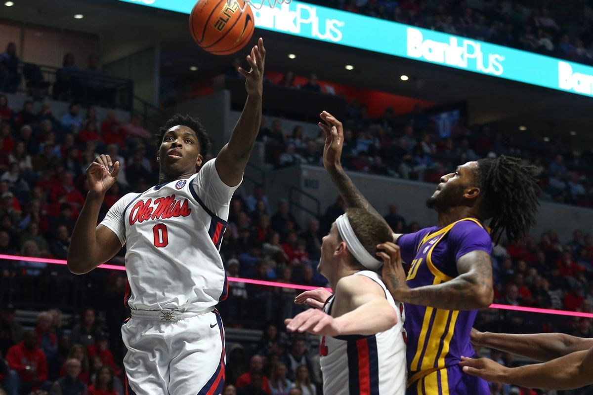 Jan 11, 2025; Oxford, Mississippi, USA; Mississippi Rebels forward Malik Dia (0) collects a rebound over Mississippi Rebels guard Sean Pedulla (3) and LSU Tigers forward Daimion Collins (10) during the first half at The Sandy and John Black Pavilion at Ole Miss. Mandatory Credit: Petre Thomas-Imagn Images