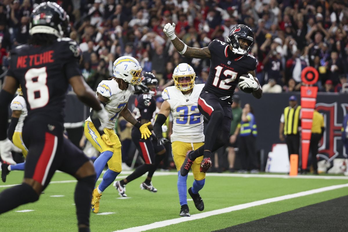 Jan 11, 2025; Houston, Texas, USA;  Houston Texans wide receiver Nico Collins (12) scores a touchdown against the Los Angeles Chargers in the second quarter in an AFC wild card game at NRG Stadium. Mandatory Credit: Thomas Shea-Imagn Images