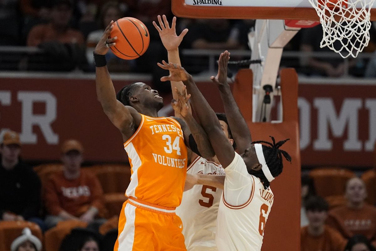 Jan 11, 2025; Austin, Texas, USA; Tennessee Volunteers forward Felix Okpara (34) shoots the ball over Texas Longhorns forward Arthur Kaluma (6) and forward Kadin Shedrick (5) during the first half at Moody Center. Mandatory Credit: Scott Wachter-Imagn Images