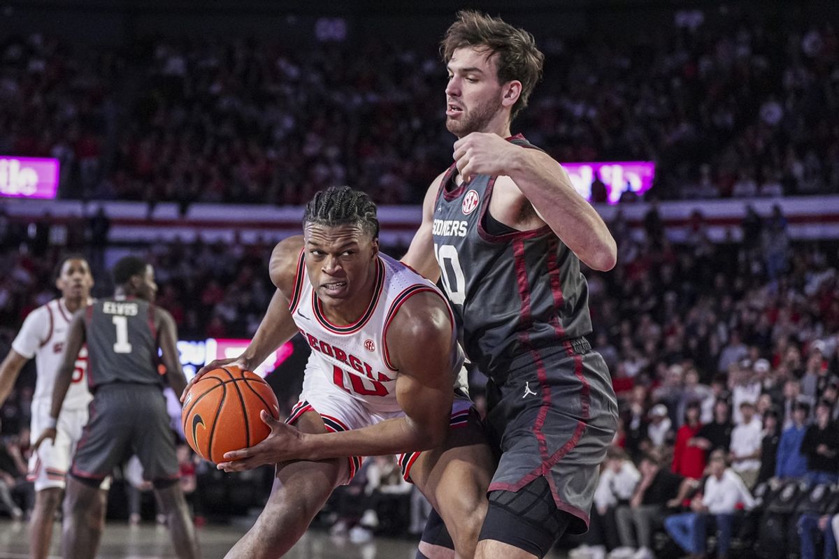 Jan 11, 2025; Athens, Georgia, USA; Georgia Bulldogs forward RJ Godfrey (10) is defended by Oklahoma Sooners forward Sam Godwin (10) during the first half at Stegeman Coliseum. Mandatory Credit: Dale Zanine-Imagn Images