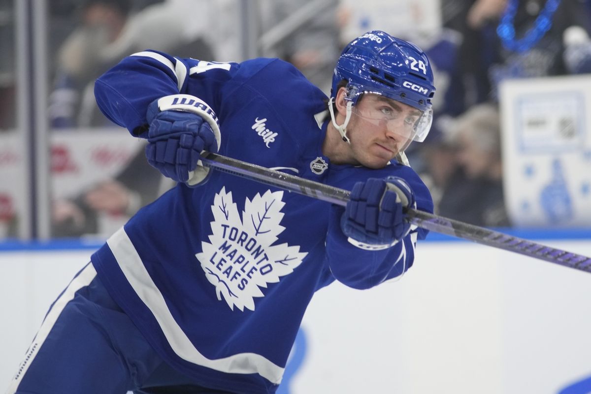 Jan 11, 2025; Toronto, Ontario, CAN; Toronto Maple Leafs forward Connor Dewar (24) shoots the puck during warm up before a game against the Vancouver Canucks at Scotiabank Arena. Mandatory Credit: John E. Sokolowski-Imagn Images