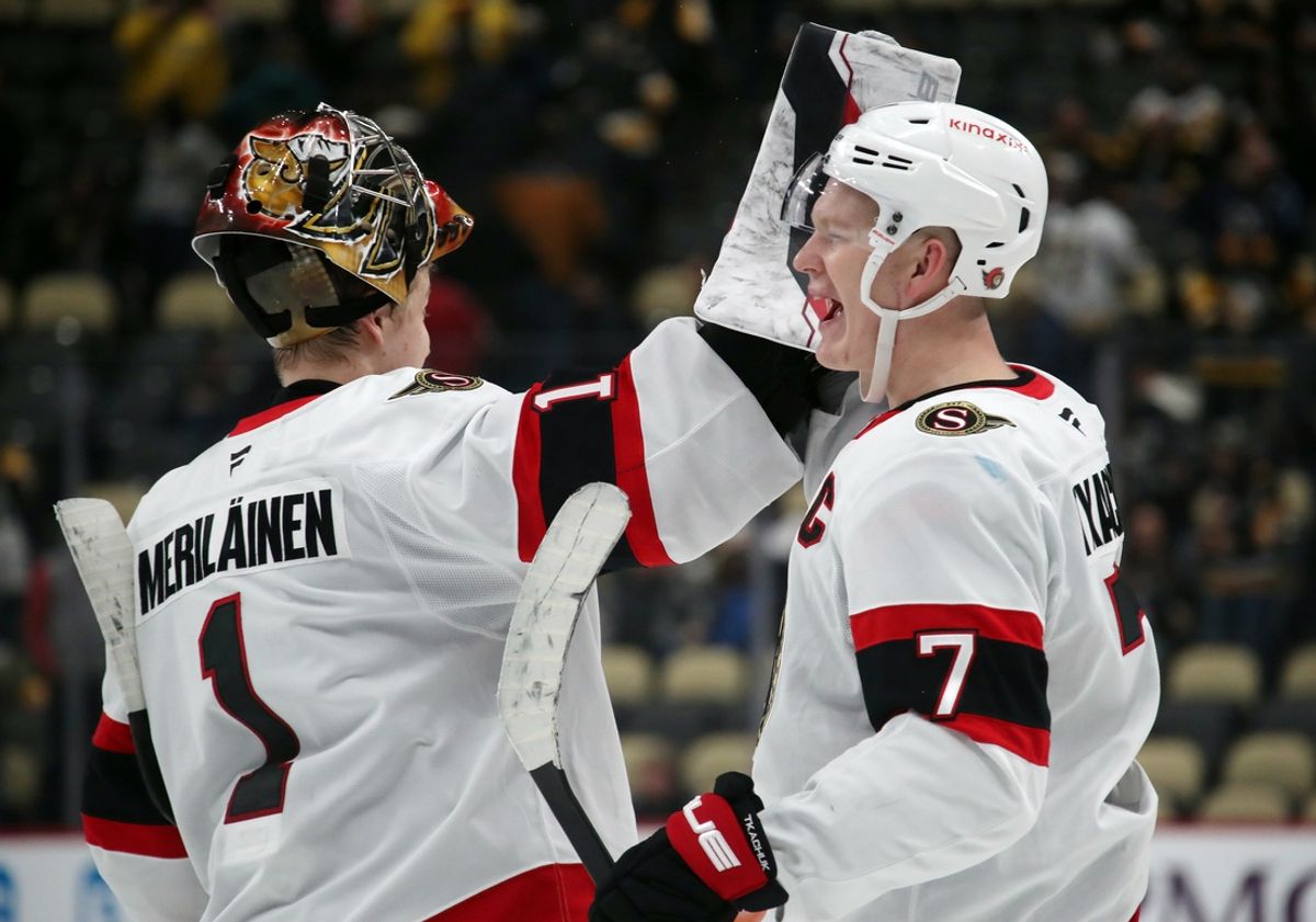 Jan 11, 2025; Pittsburgh, Pennsylvania, USA;  Ottawa Senators goaltender Leevi Merilainen (1) and left wing Brady Tkachuk (7) celebrate after defeating the Pittsburgh Penguins at PPG Paints Arena. Mandatory Credit: Charles LeClaire-Imagn Images