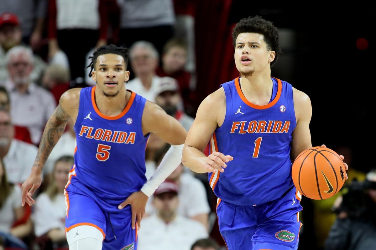 Jan 11, 2025; Fayetteville, Arkansas, USA; Florida Gators guard Walter Clayton Jr. (1) dribbles the ball as guard Will Richard (5) looks on during the second half against the Arkansas Razorbacks at Bud Walton Arena. Florida won 71-63. Mandatory Credit: Nelson Chenault-Imagn Images