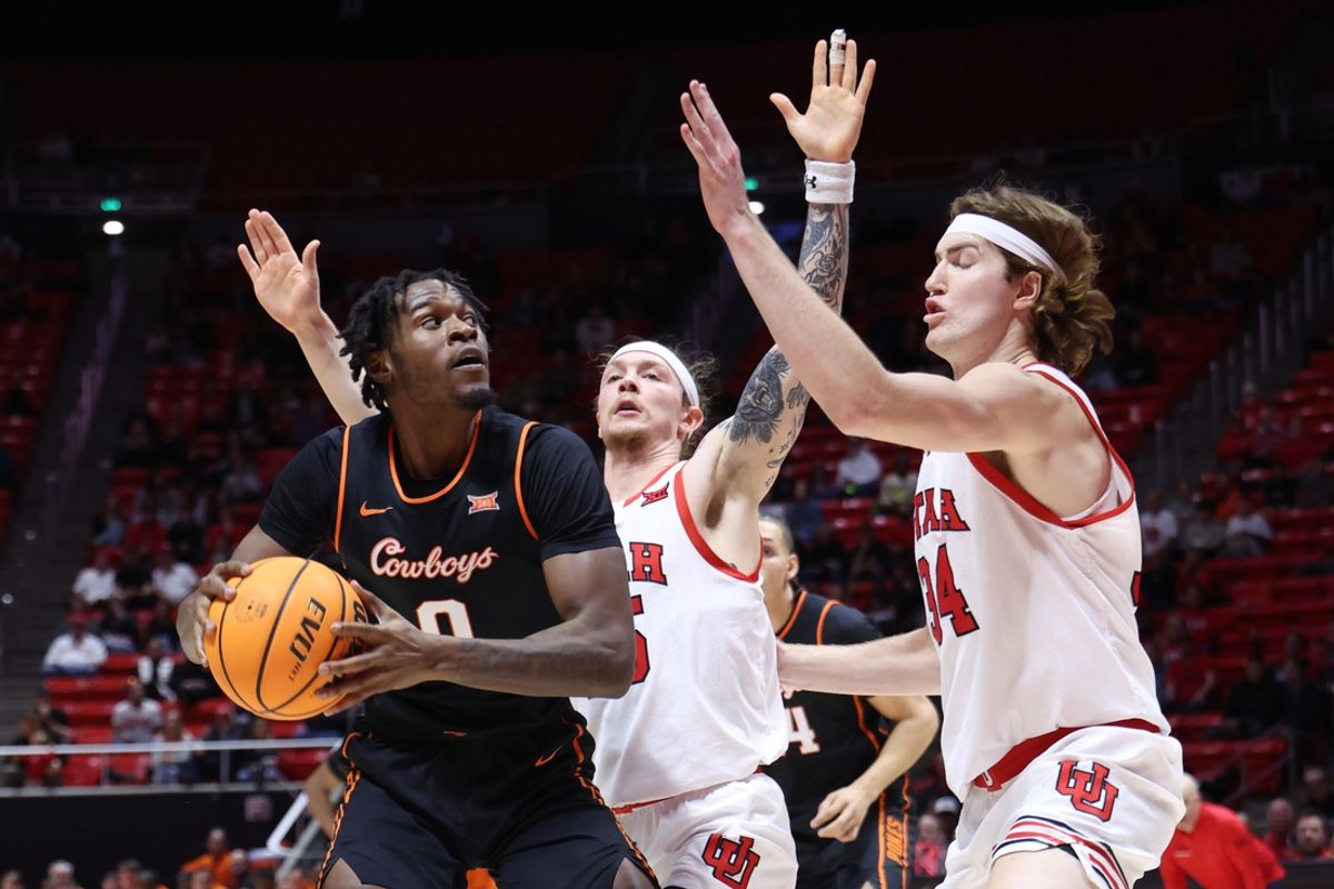 Jan 11, 2025; Salt Lake City, Utah, USA; Oklahoma State Cowboys forward Marchelus Avery (0) looks to shoot against Utah Utes guard Gabe Madsen (center) and Lawson Lovering (34) during the first half at Jon M. Huntsman Center. Mandatory Credit: Rob Gray-Imagn Images