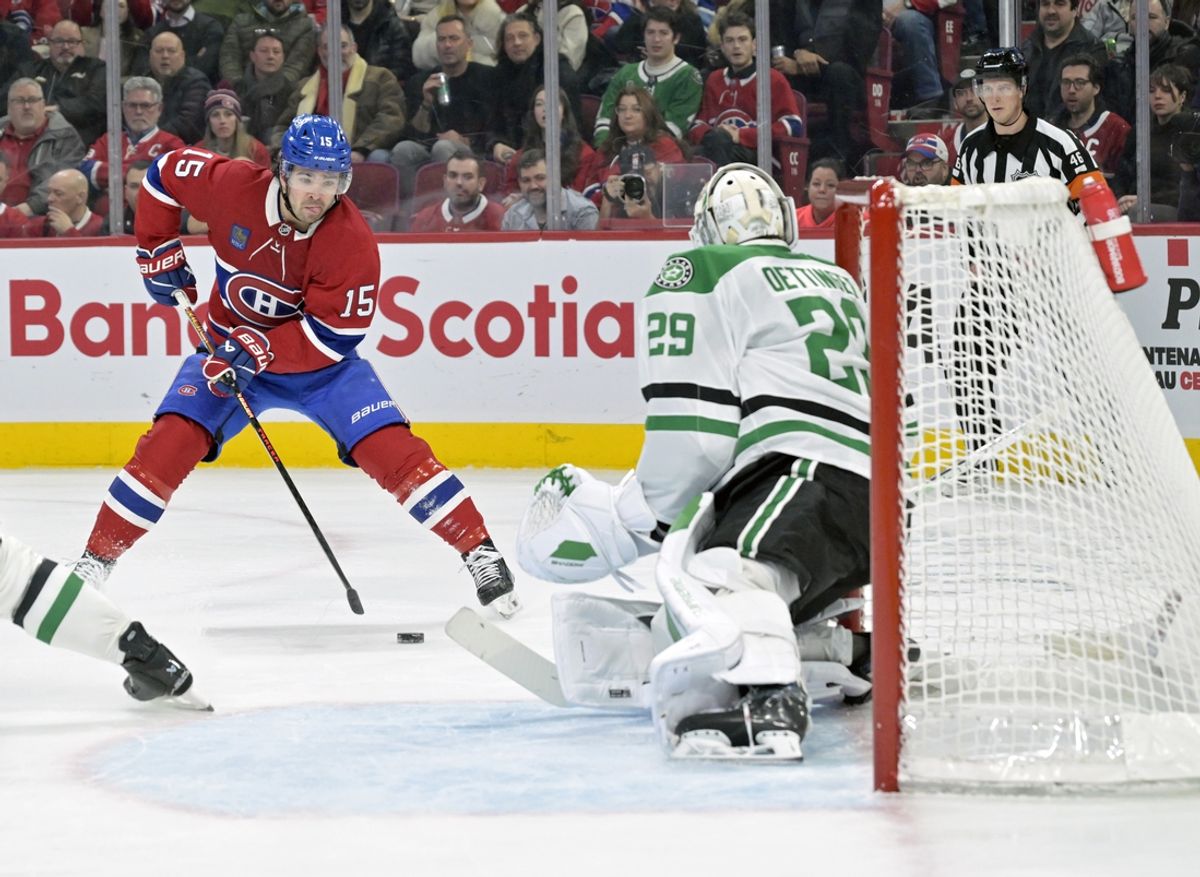 Jan 11, 2025; Montreal, Quebec, CAN; Montreal Canadiens forward Alex Newhook (15) plays the puck against Dallas Stars goalie Jake Oettinger (29) during the first period at the Bell Centre. Mandatory Credit: Eric Bolte-Imagn Images