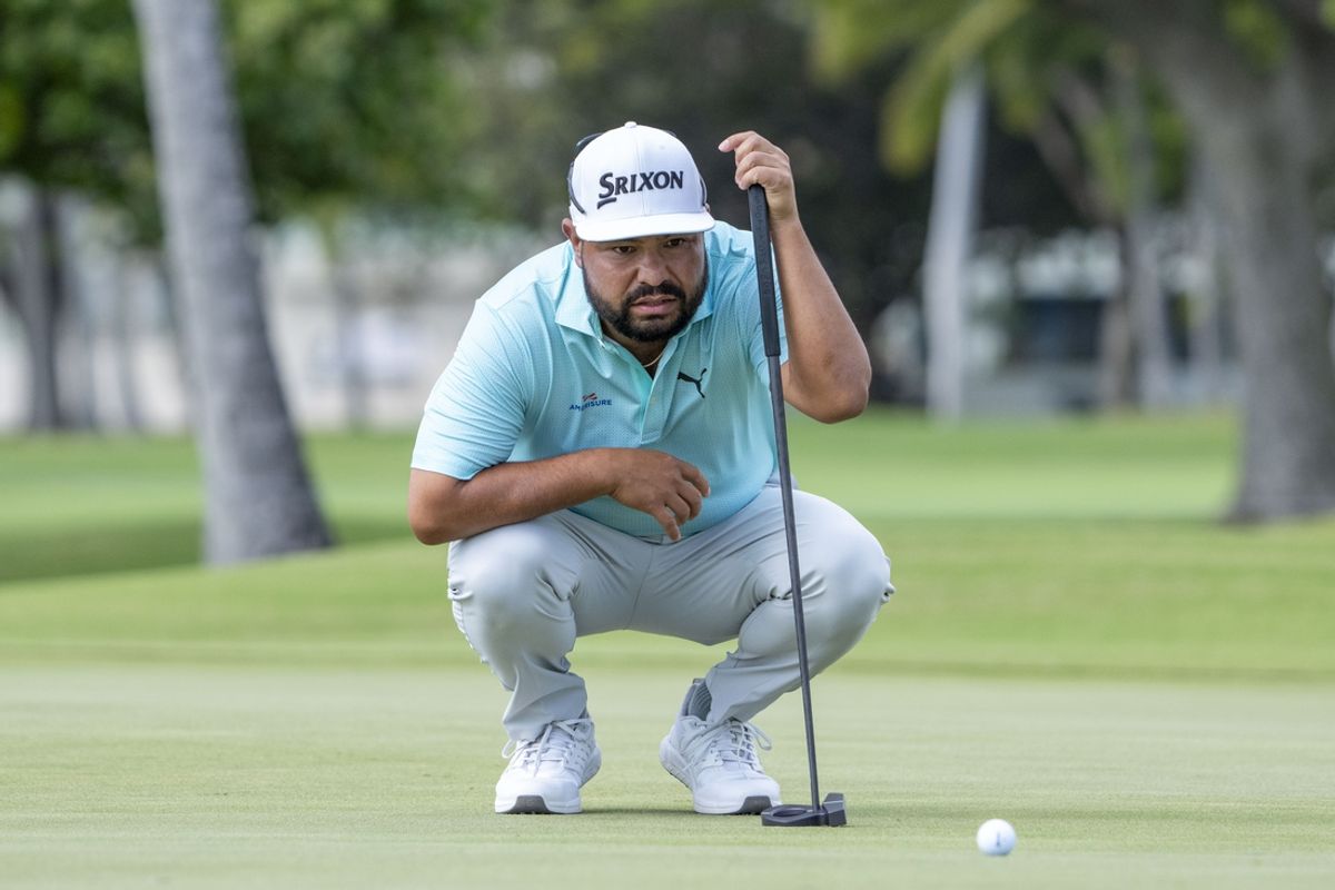 January 11, 2025; Honolulu, Hawaii, USA; J.J. Spaun lines up his putt on the 13th hole during the third round of the Sony Open golf tournament at Waialae Country Club. Mandatory Credit: Kyle Terada-Imagn Images