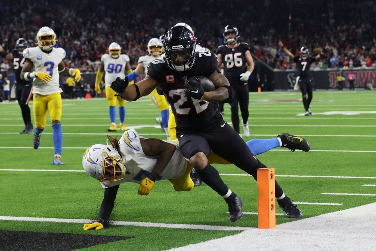 Jan 11, 2025; Houston, Texas, USA;  Houston Texans running back Joe Mixon (28) scores a touchdown against the Los Angeles Chargers in the fourth quarter in an AFC wild card game at NRG Stadium. Mandatory Credit: Thomas Shea-Imagn Images