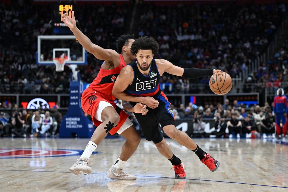 Jan 11, 2025; Detroit, Michigan, USA;  Detroit Pistons guard Cade Cunningham (2) drives past Toronto Raptors forward Scottie Barnes (4) in the second quarter at Little Caesars Arena. Mandatory Credit: Lon Horwedel-Imagn Images