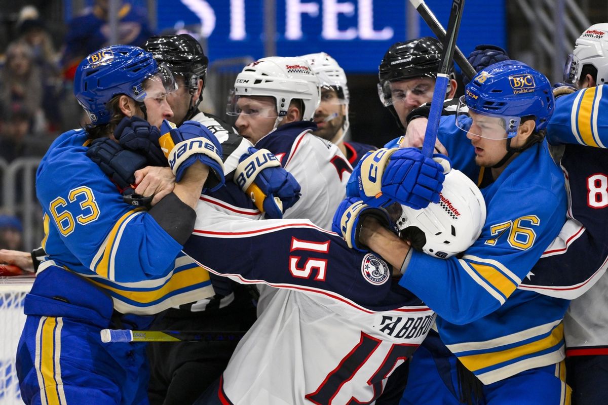 Jan 11, 2025; St. Louis, Missouri, USA;  St. Louis Blues left wing Jake Neighbours (63) and center Zack Bolduc (76) get physical with Columbus Blue Jackets defenseman Dante Fabbro (15) during the second period at Enterprise Center. Mandatory Credit: Jeff Curry-Imagn Images