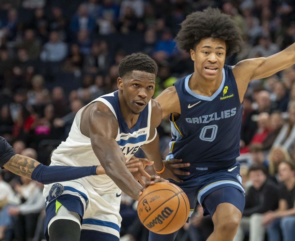 Jan 11, 2025; Minneapolis, Minnesota, USA; Minnesota Timberwolves guard Anthony Edwards (5) dribbles the ball against Memphis Grizzlies forward Jaylen Wells (0) in the first half at Target Center. Mandatory Credit: Jesse Johnson-Imagn Images