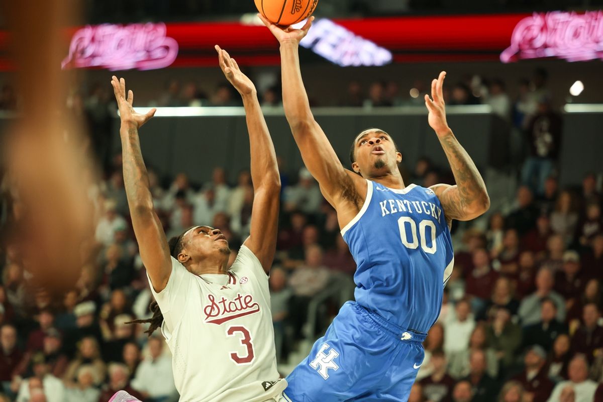 Jan 11, 2025; Starkville, Mississippi, USA; Kentucky Wildcats guard Otega Oweh (00) shoots against Mississippi State Bulldogs forward KeShawn Murphy (3) during the first half at Humphrey Coliseum. Mandatory Credit: Wesley Hale-Imagn Images
