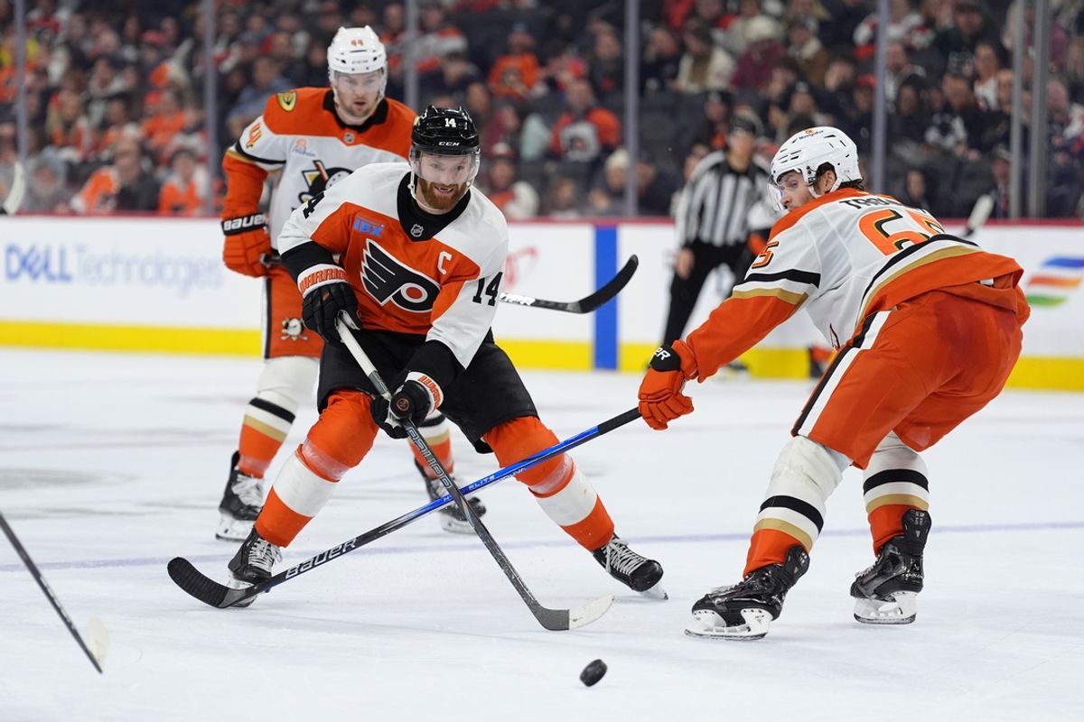 Jan 11, 2025; Philadelphia, Pennsylvania, USA; Philadelphia Flyers center Sean Couturier (14) passes the puck against the Anaheim Ducks in the third period at Wells Fargo Center. Mandatory Credit: Kyle Ross-Imagn Images