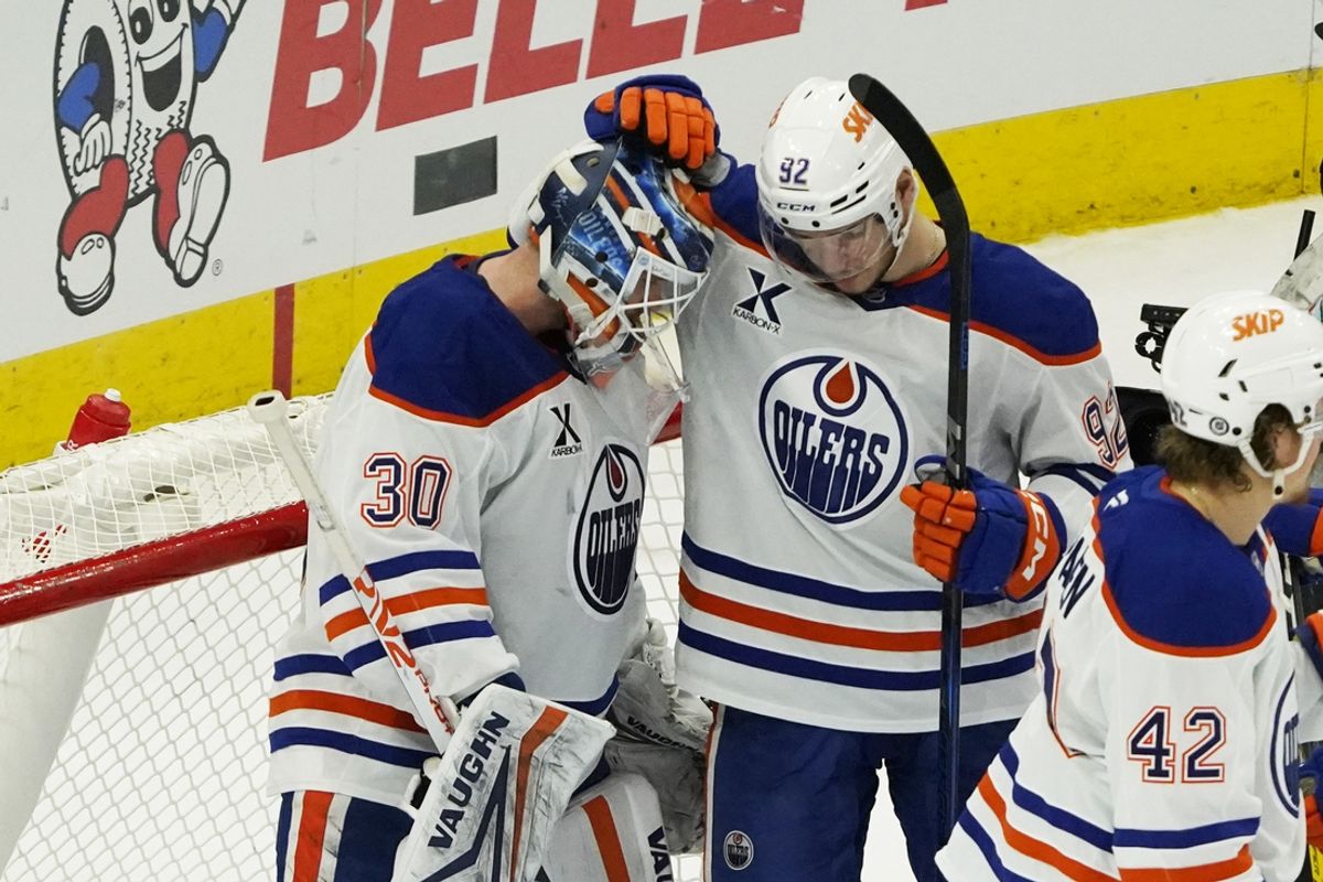 Jan 11, 2025; Chicago, Illinois, USA; Edmonton Oilers goaltender Calvin Pickard (30) and right wing Vasily Podkolzin (92) celebrate their win against the Chicago Blackhawks at United Center. Mandatory Credit: David Banks-Imagn Images