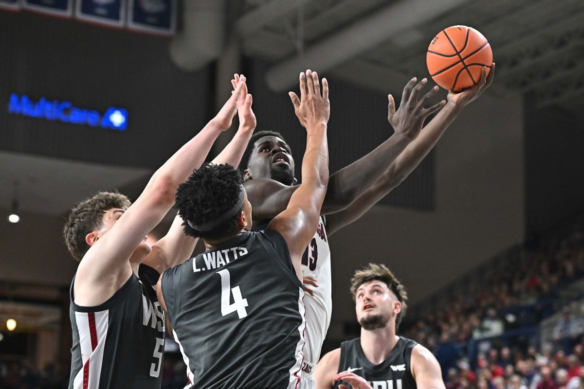 Jan 11, 2025; Spokane, Washington, USA; Gonzaga Bulldogs forward Graham Ike (13) puts up a shot against Washington State Cougars forward LeJuan Watts (4) and Washington State Cougars guard Tomas Thrastarson (5) in the first half at McCarthey Athletic Center. Mandatory Credit: James Snook-Imagn Images