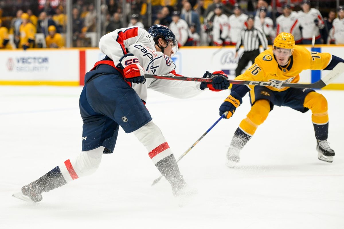 Jan 11, 2025; Nashville, Tennessee, USA;  Washington Capitals center Dylan Strome (17) takes a shot on goal against the Nashville Predators during the second period at Bridgestone Arena. Mandatory Credit: Steve Roberts-Imagn Images