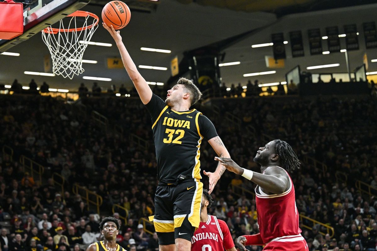 Jan 11, 2025; Iowa City, Iowa, USA; Iowa Hawkeyes forward Owen Freeman (32) drives to the basket against Indiana Hoosiers center Oumar Ballo (11) during the second half at Carver-Hawkeye Arena. Mandatory Credit: Jeffrey Becker-Imagn Images