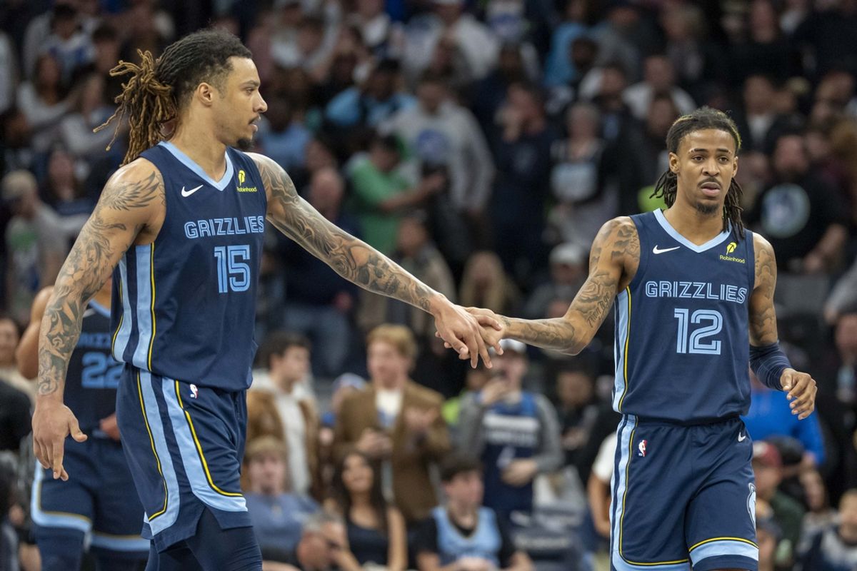 Jan 11, 2025; Minneapolis, Minnesota, USA; Memphis Grizzlies forward Brandon Clarke (15) and guard Ja Morant (12) celebrate after defeating the Minnesota Timberwolves at Target Center. Mandatory Credit: Jesse Johnson-Imagn Images
