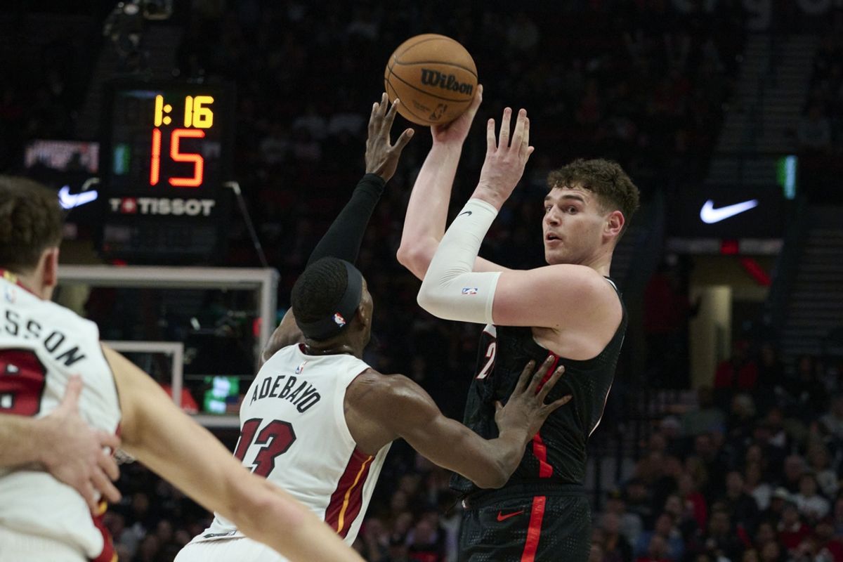 Jan 11, 2025; Portland, Oregon, USA; Portland Trail Blazers center Donovan Clingan (23) passes the ball during the first half against Miami Heat center Bam Adebayo (13) at Moda Center. Mandatory Credit: Troy Wayrynen-Imagn Images