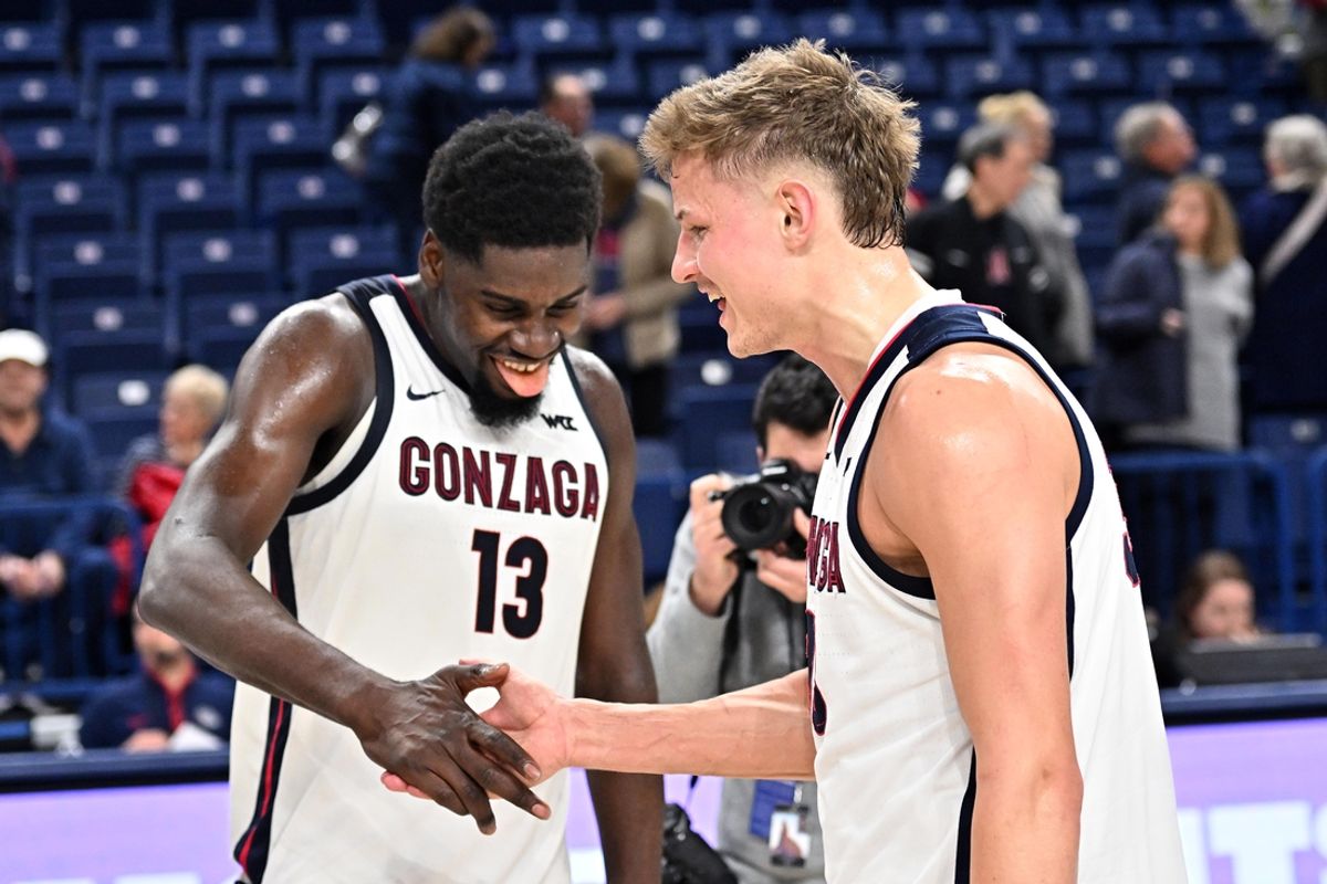 Jan 11, 2025; Spokane, Washington, USA; Gonzaga Bulldogs forward Graham Ike (13) and Gonzaga Bulldogs forward Ben Gregg (33) celebrate after a game against the Washington State Cougars at McCarthey Athletic Center. Mandatory Credit: James Snook-Imagn Images