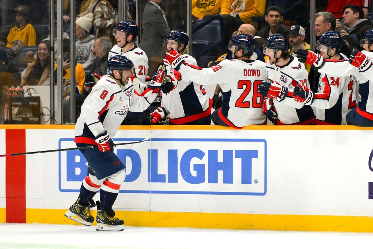 Jan 11, 2025; Nashville, Tennessee, USA;  Washington Capitals left wing Alex Ovechkin (8) celebrates with teammates after scoring a goal against the Nashville Predators during the third period at Bridgestone Arena. Mandatory Credit: Steve Roberts-Imagn Images