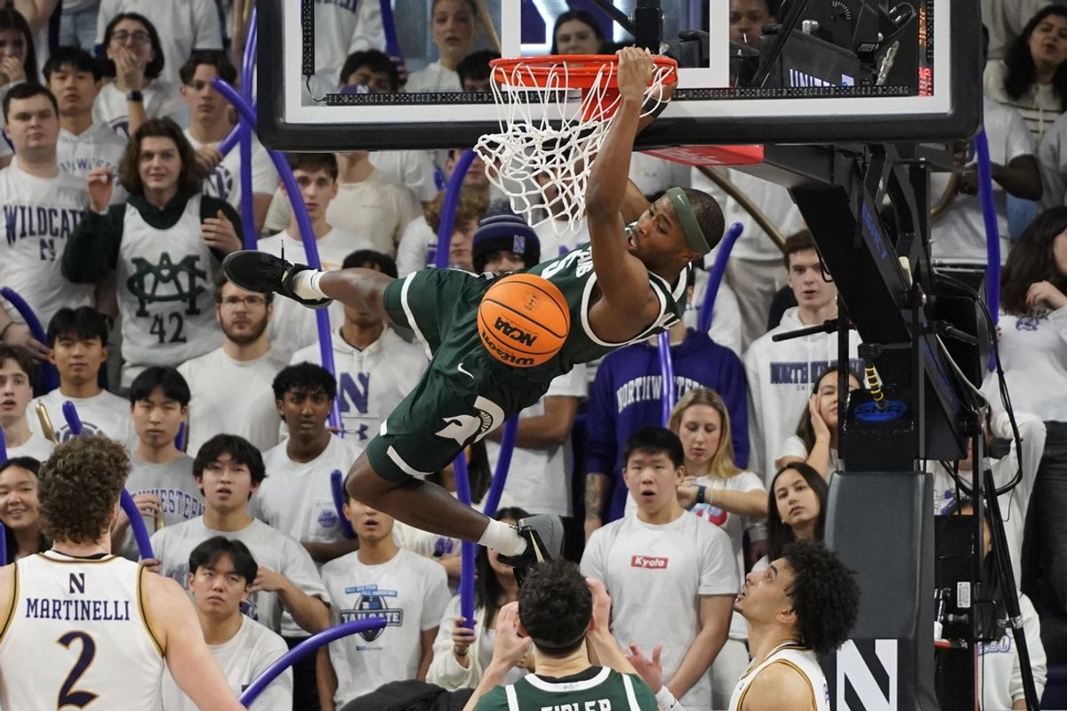 Jan 12, 2025; Evanston, Illinois, USA; Michigan State Spartans guard Tre Holloman (5) dunks the ball against the Northwestern Wildcats during the second half at Welsh-Ryan Arena. Mandatory Credit: David Banks-Imagn Images