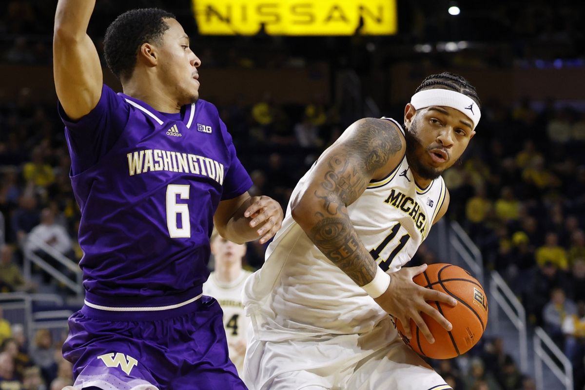 Jan 12, 2025; Ann Arbor, Michigan, USA; Michigan Wolverines guard Roddy Gayle Jr. (11) is defended by Washington Huskies guard Tyree Ihenacho (6) in the first half at Crisler Center. Mandatory Credit: Rick Osentoski-Imagn Images