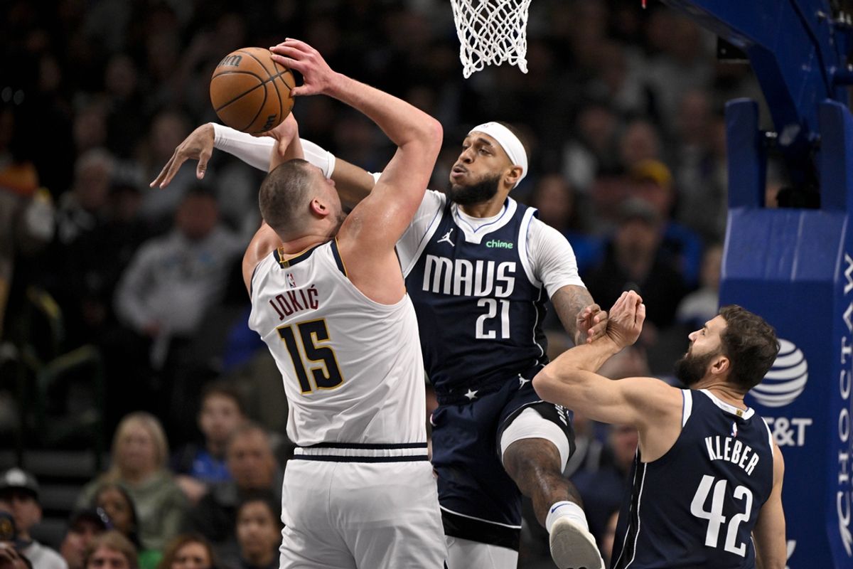 Jan 12, 2025; Dallas, Texas, USA; Dallas Mavericks center Daniel Gafford (21) blocks a shot by Denver Nuggets center Nikola Jokic (15) during the first quarter at the American Airlines Center. Mandatory Credit: Jerome Miron-Imagn Images