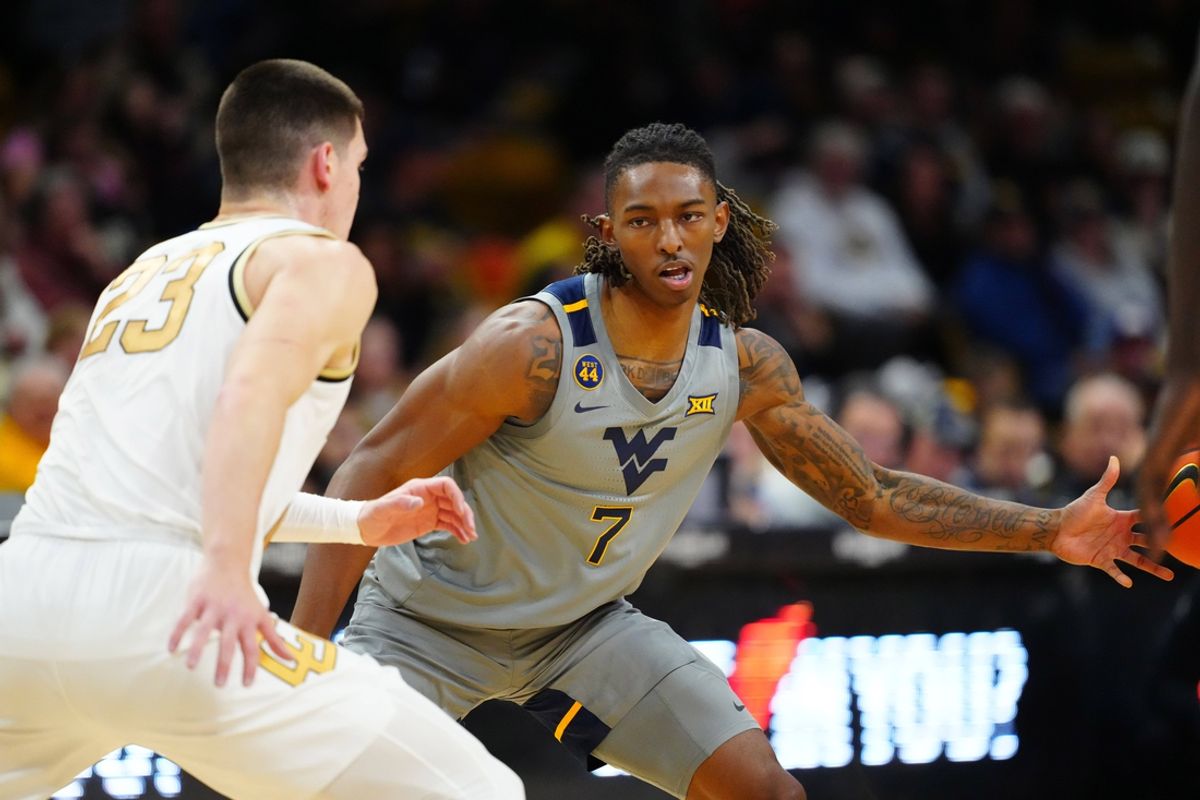 Jan 12, 2025; Boulder, Colorado, USA; West Virginia Mountaineers guard Javon Small (7) passes the ball away from Colorado Buffaloes forward Andrej Jakimovski (23) in the first half at CU Events Center. Mandatory Credit: Ron Chenoy-Imagn Images