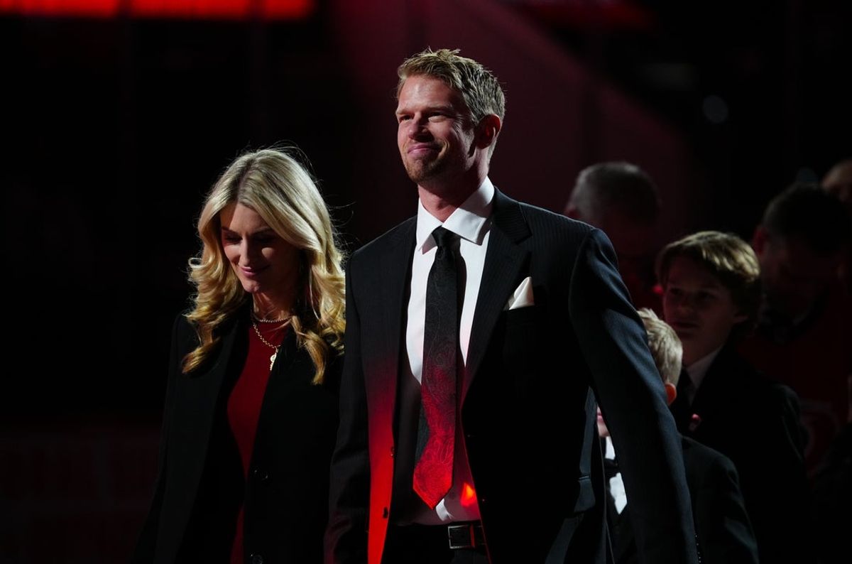 Jan 12, 2025; Raleigh, North Carolina, USA;  Carolina Hurricanes center Eric Staal (12) looks on with his wife Tanya during his retirement of his jersey before the game against the Anaheim Ducks at Lenovo Center. Mandatory Credit: James Guillory-Imagn Images
