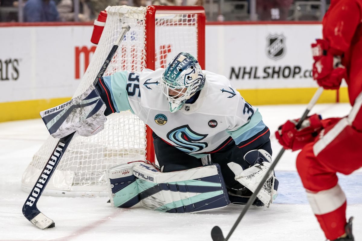 Jan 12, 2025; Detroit, Michigan, USA;  Seattle Kraken goalie Joey Daccord (35) gathers the puck against the Detroit Red Wings during the second period at Little Caesars Arena. Mandatory Credit: Nick Wosika-Imagn Images