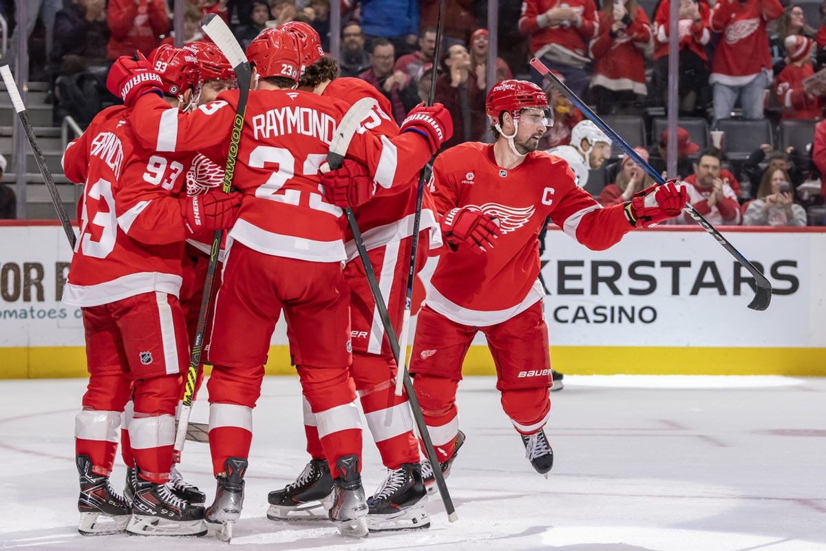 Jan 12, 2025; Detroit, Michigan, USA;  Detroit Red Wings forward Dylan Larkin (71) heads to the bench after celebrating his power play goal against the Seattle Kraken with forward Alex DeBrincat (93), forward Lucas Raymond (23), and defenseman Moritz Seider (53) during the second period at Little Caesars Arena. Mandatory Credit: Nick Wosika-Imagn Images